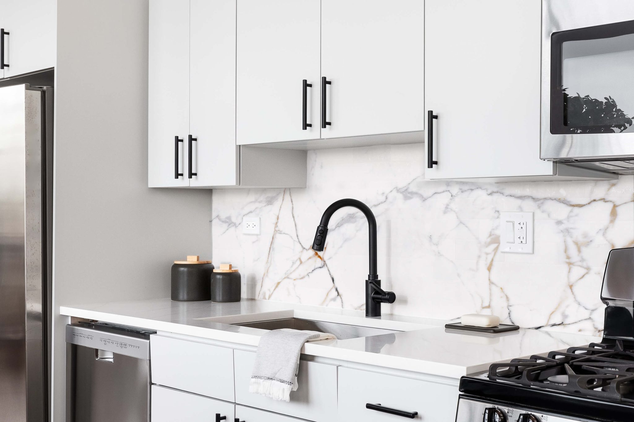 White flat-panel cabinets with black hardware